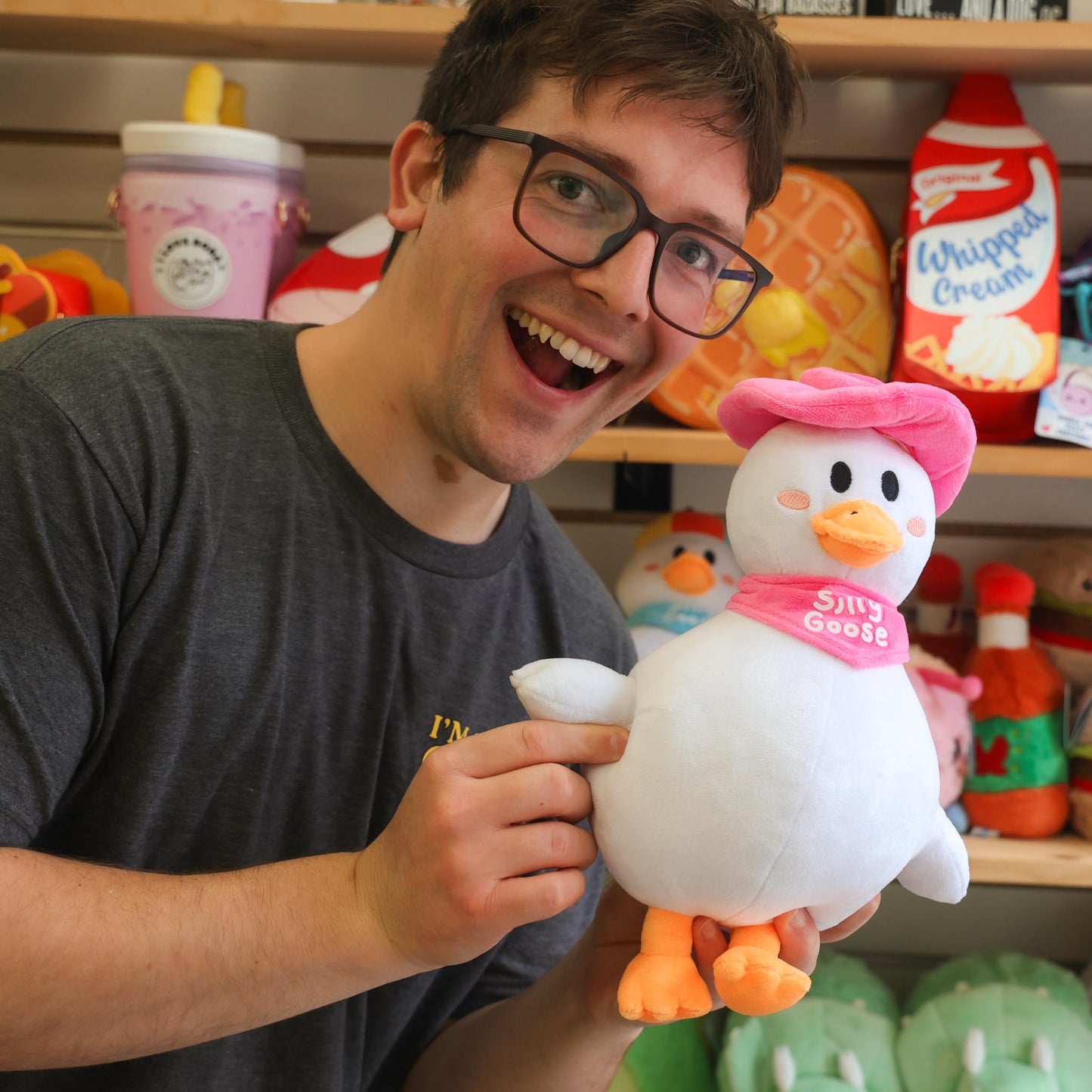 Nate holding a plush silly goose toy with a colorful background