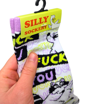 Silly Goose Sock with offensive language held by a hand, branded 'Silly Sockery' on a yellow tag.