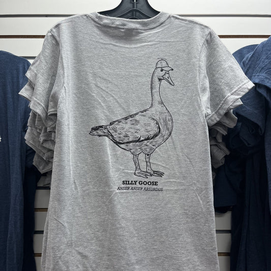 Gray t-shirt with a goose graphic and text on a hanger against a striped wall.