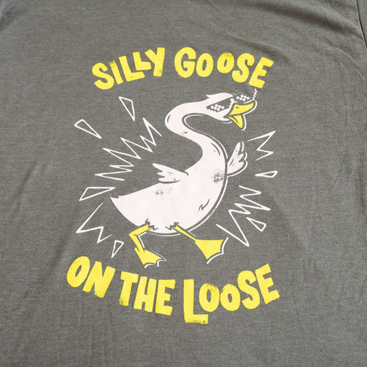 Gray t-shirt with a graphic of a goose and text 'Silly Goose on the Loose' in yellow and white.