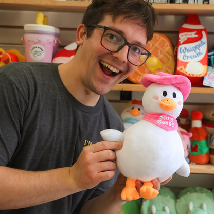 Nate holding a plush silly goose toy with a colorful background